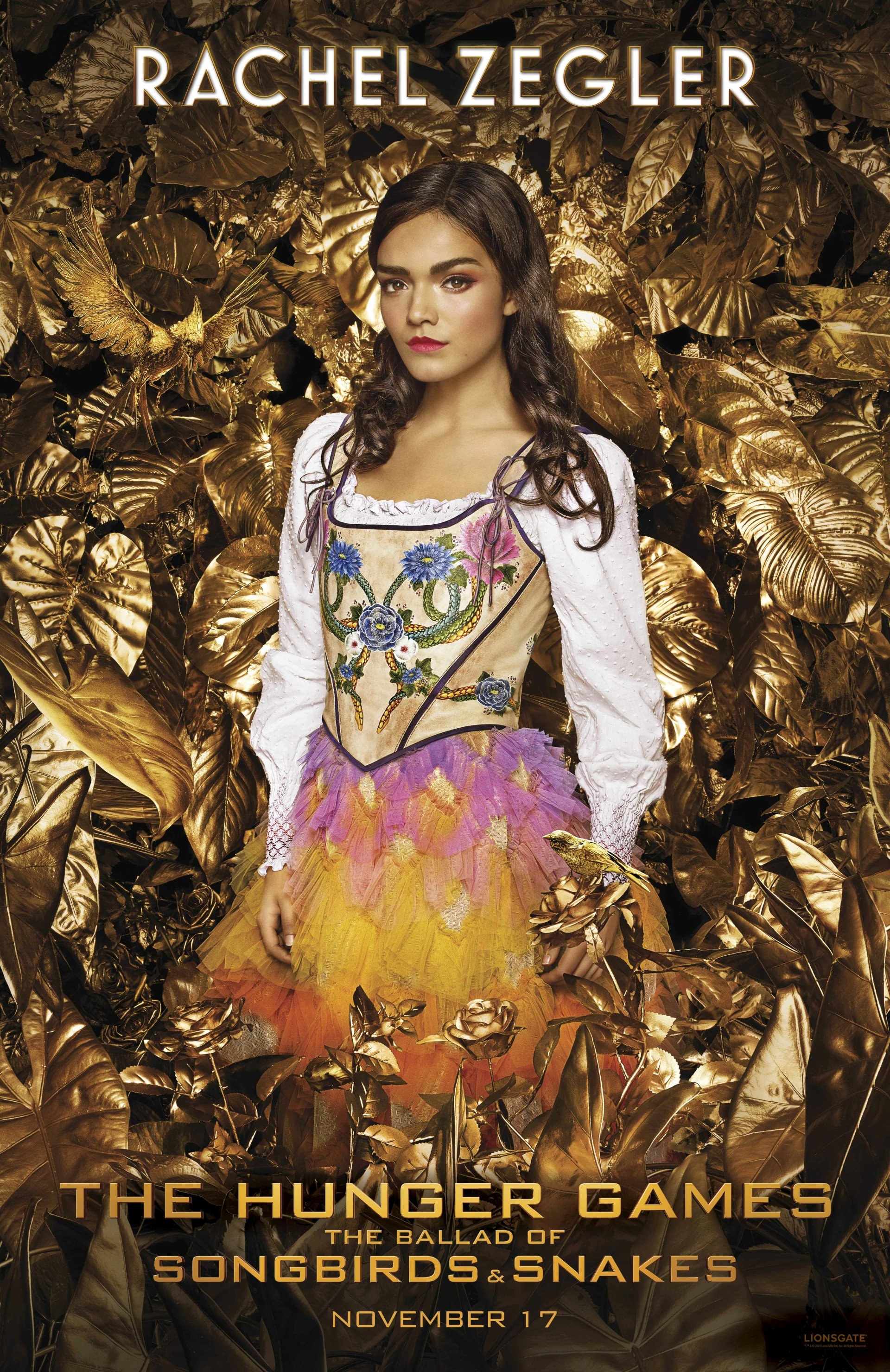 Promotional phone wallpaper featuring a character from The Hunger Games: The Ballad of Songbirds & Snakes movie, set against a golden foliage backdrop, slated for release in November.