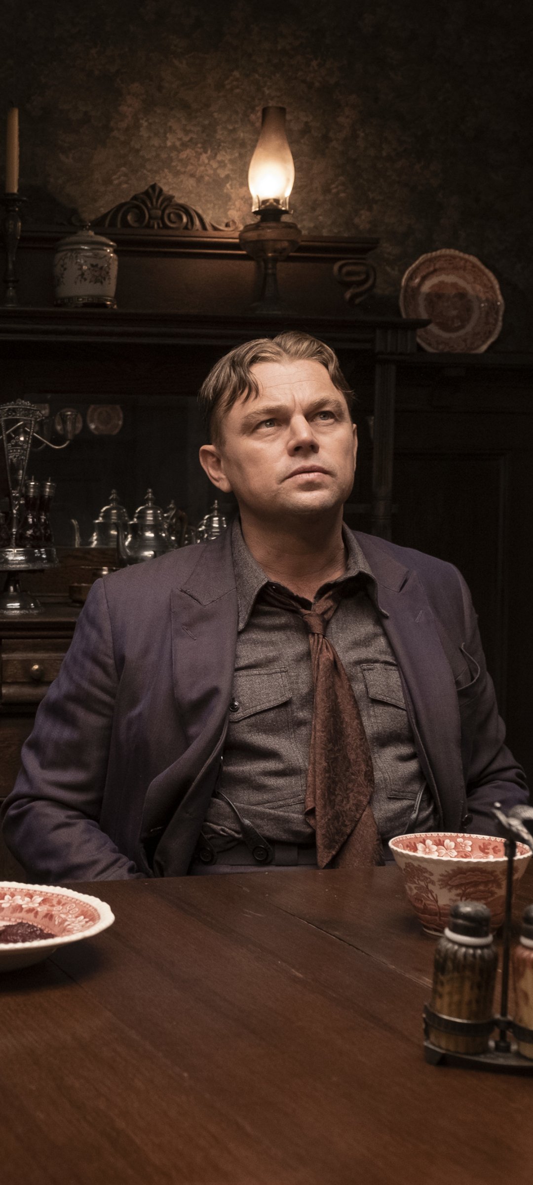 Phone wallpaper featuring a pensive man in a historical setting from 'Killers of the Flower Moon'.