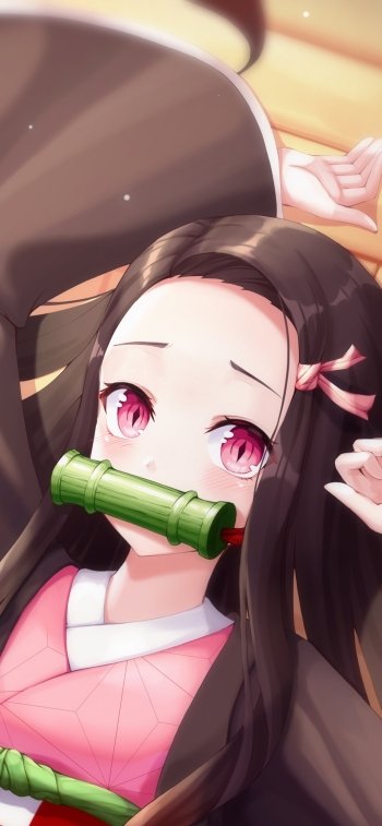 Anime-style phone wallpaper of Nezuko Kamado from Demon Slayer: Kimetsu no Yaiba, featuring her signature bamboo muzzle and pink eyes, compatible with iPhones and Android devices.