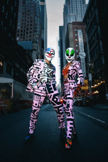 Payday 3 themed mobile wallpaper featuring two characters in stylized neon suits and masks against a city backdrop.