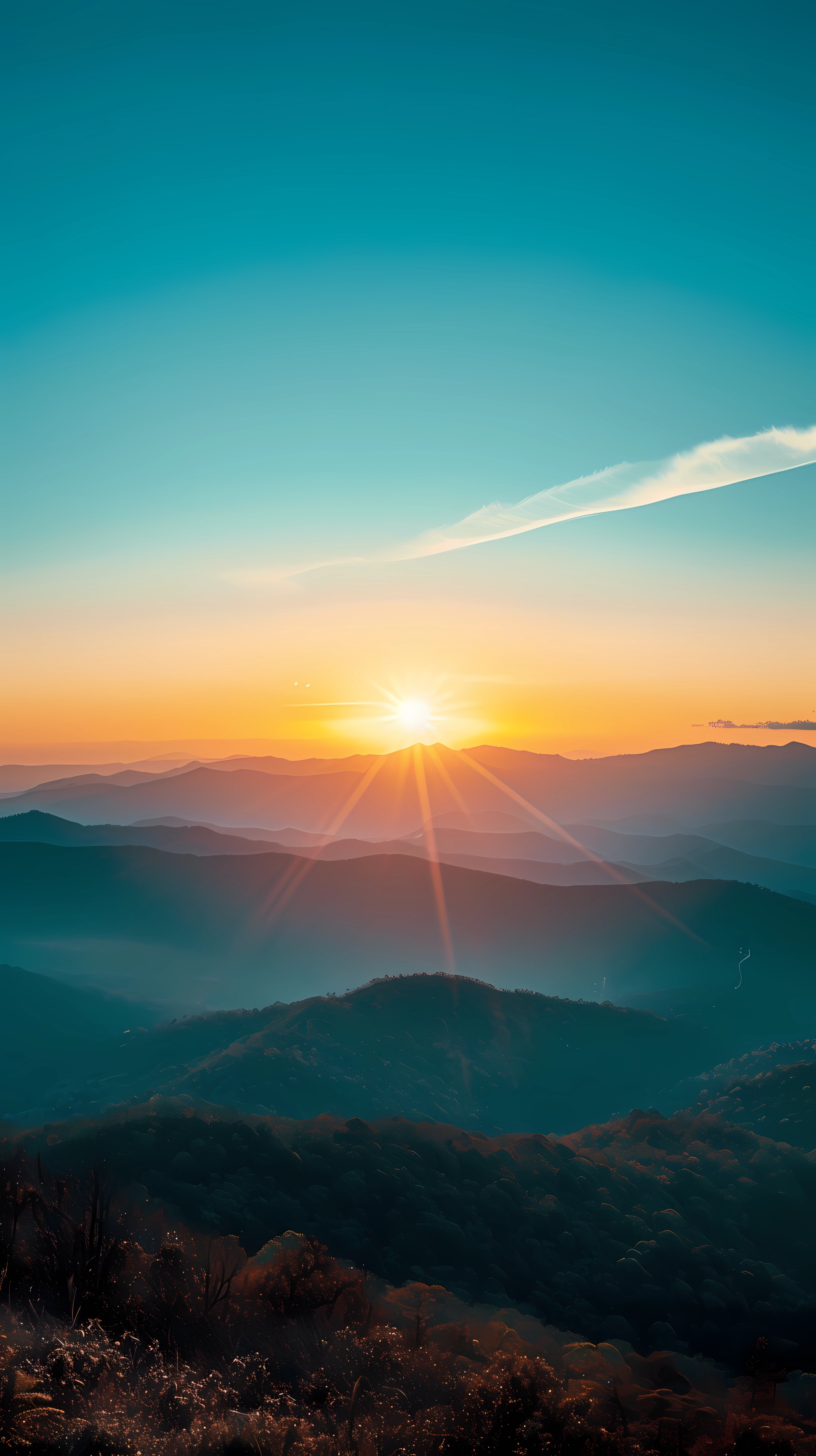 Sunrise over mountain landscape phone wallpaper with sun kissing the horizon.