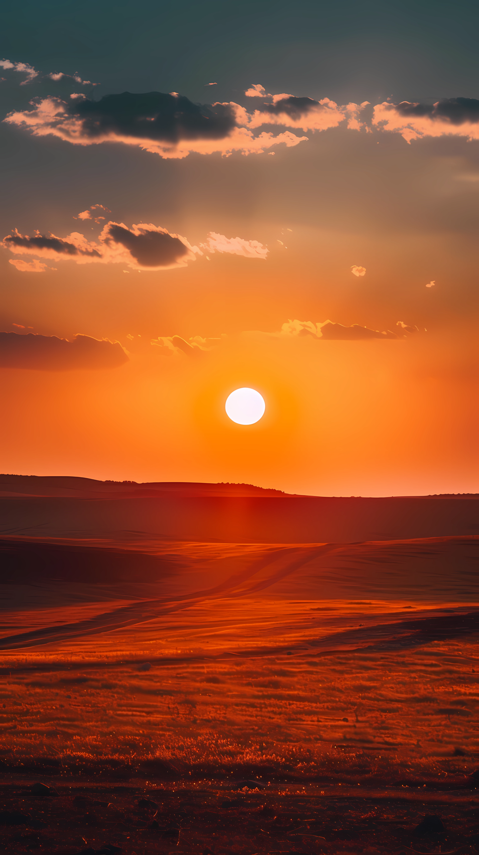 Sunset over landscape horizon, warm hues, for phone wallpaper use.