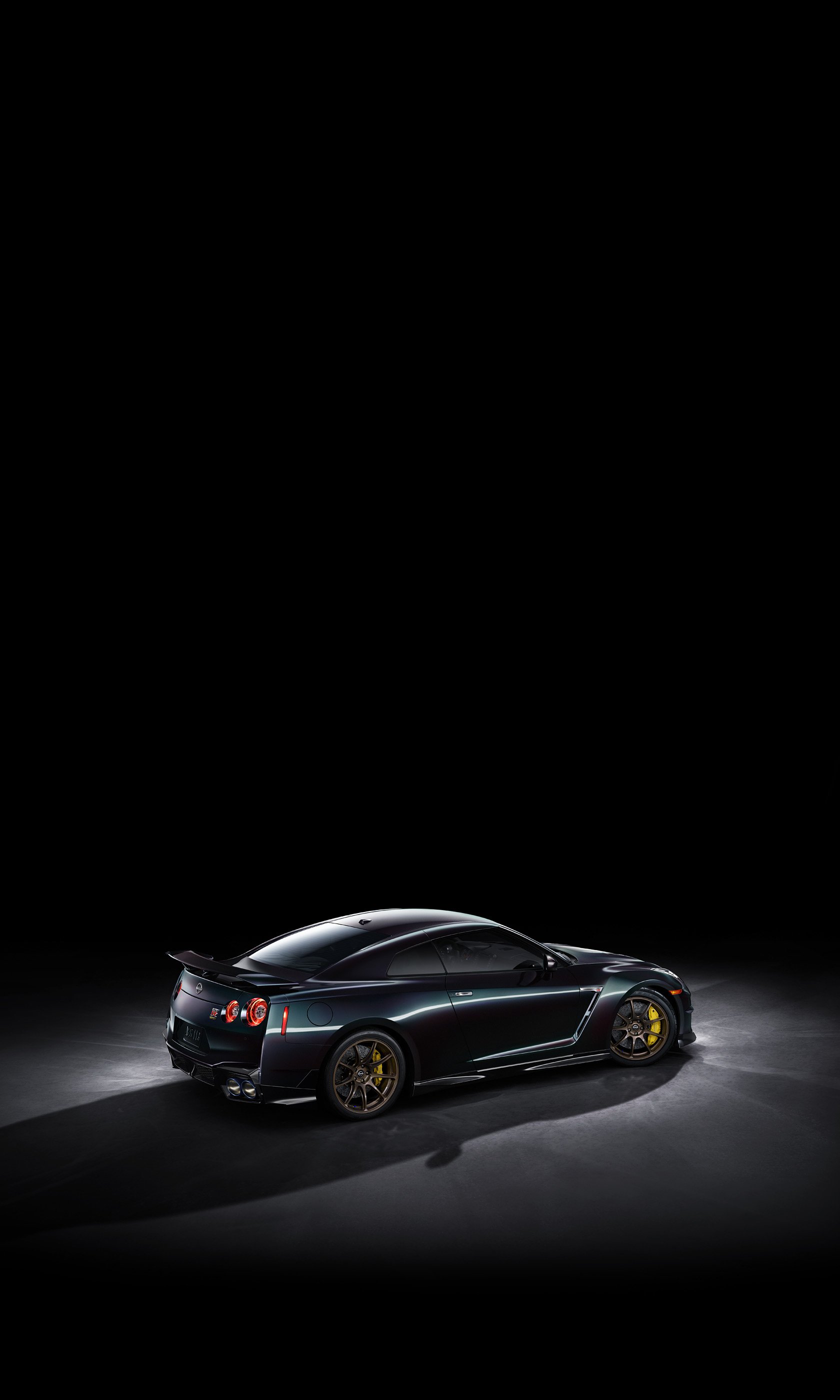 Nissan GT-R T-Spec Takumi Edition showcased in sleek black with striking yellow accents, set against a dark background, making an eye-catching phone wallpaper.