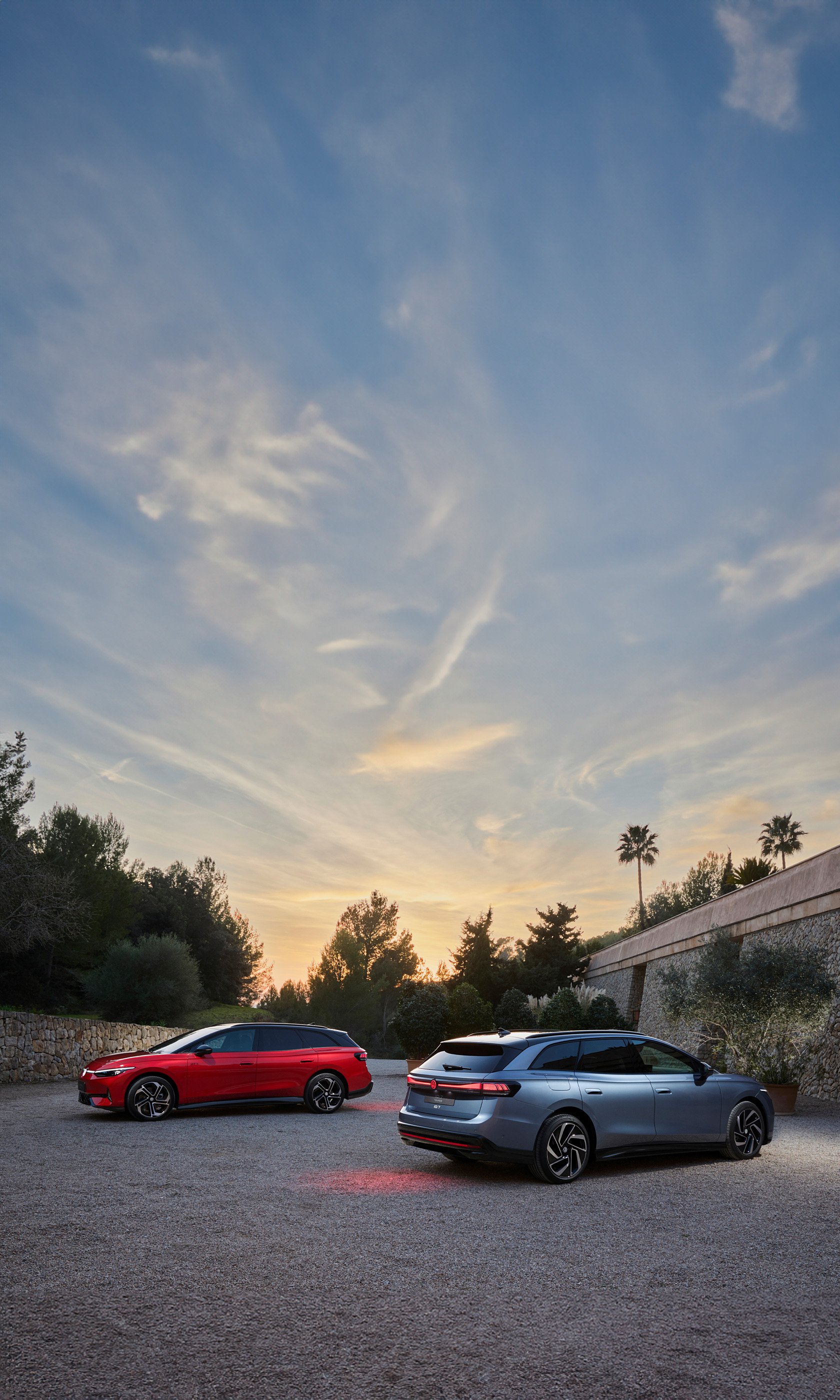 Volkswagen ID.7 GTX Tourer cars parked outdoors at dusk, suitable as a phone wallpaper.