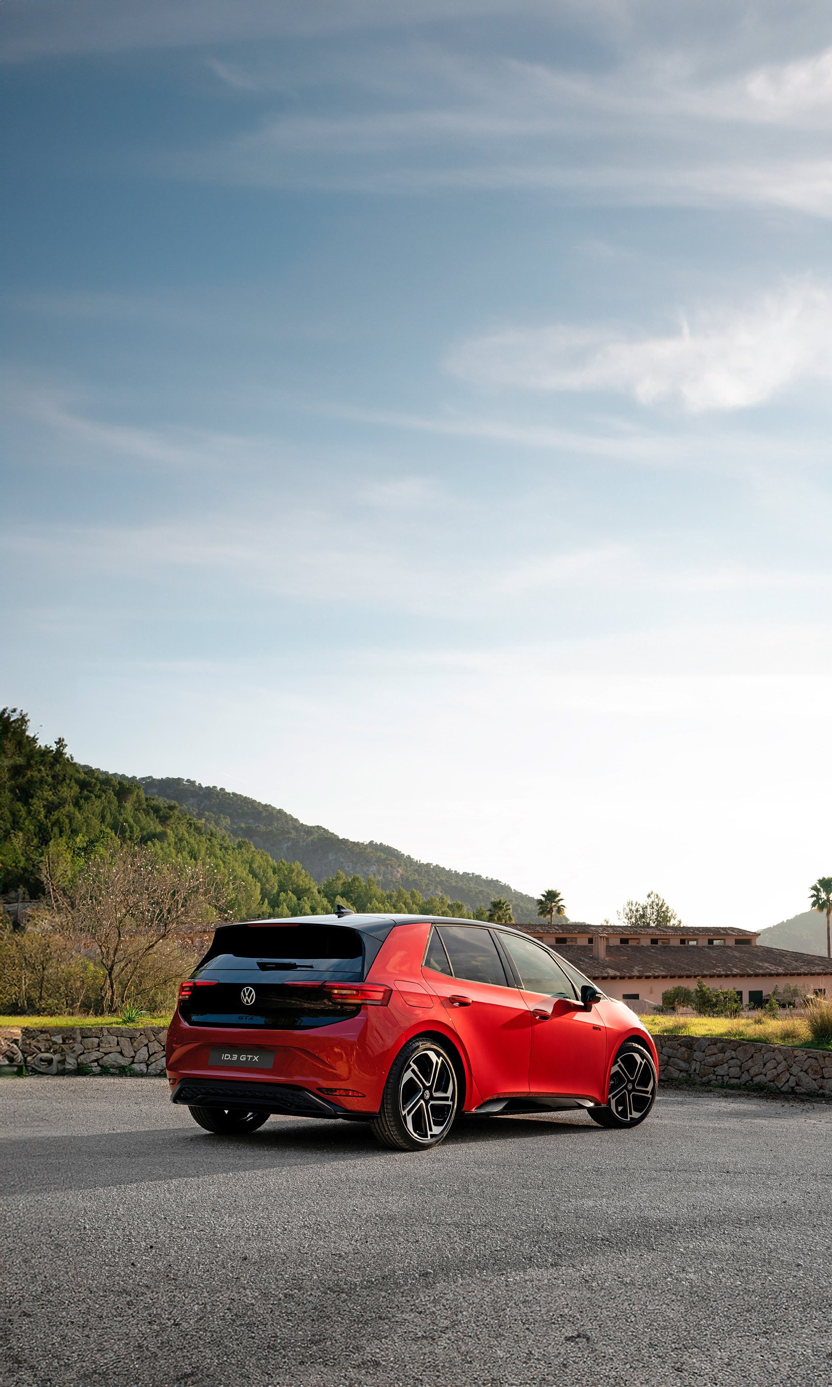 Volkswagen ID.3 GTX electric car parked outside with a scenic backdrop, optimized for use as a mobile phone wallpaper.
