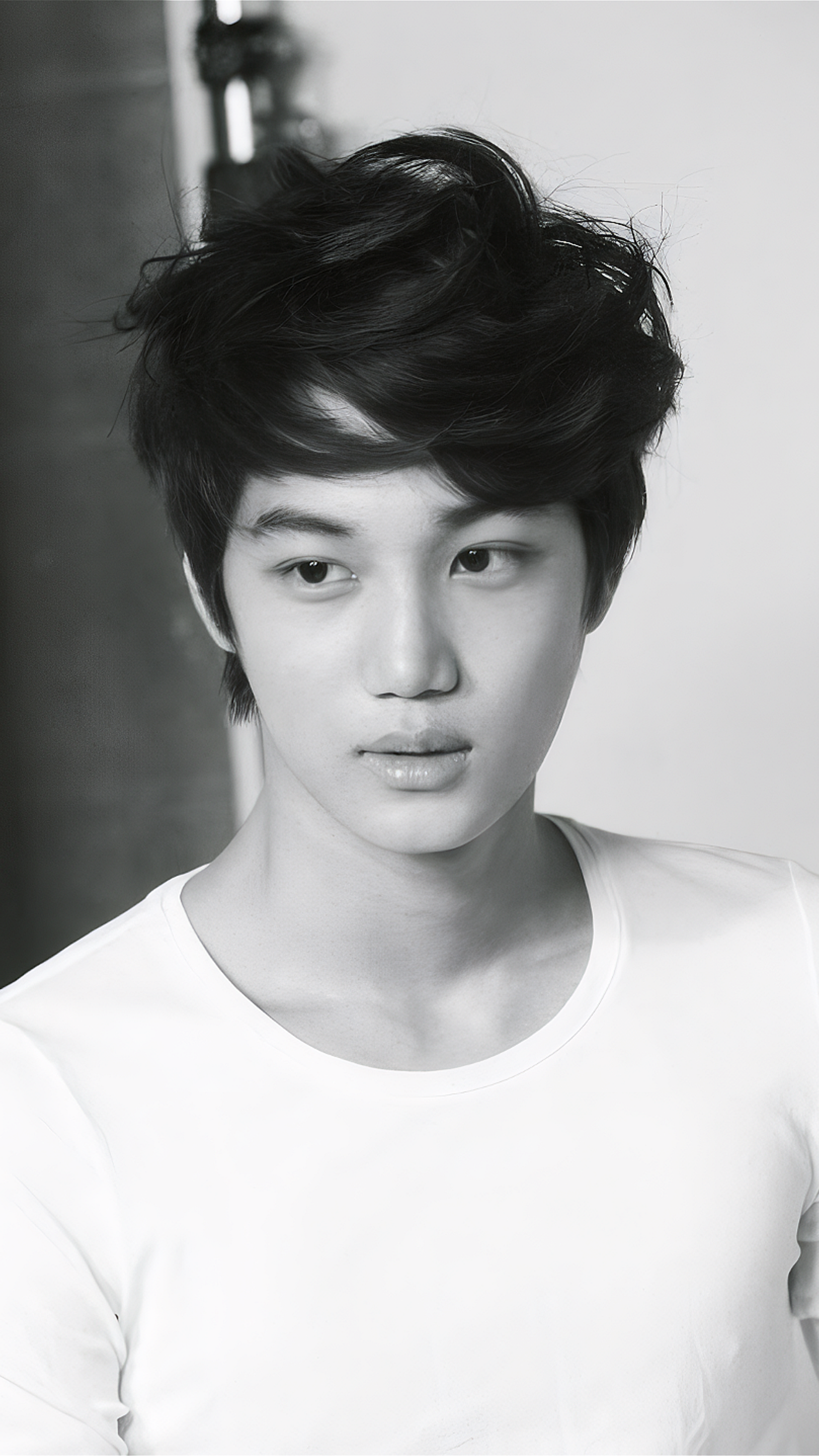 Black and white phone wallpaper of EXO member Kai from Mama era, designed for EXO-L fans on iPhone and Android devices.