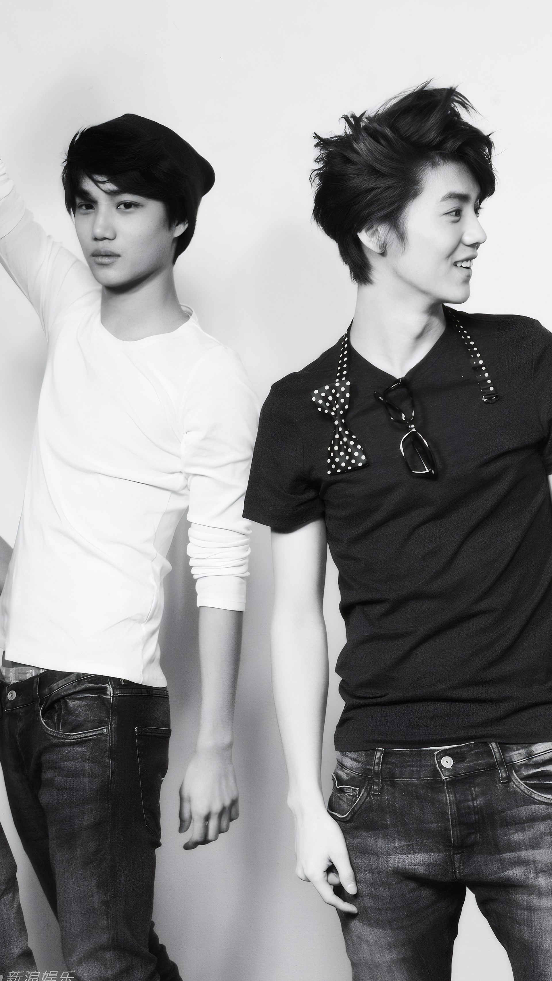 Black and white photoshoot wallpaper featuring EXO's Kai in casual jeans and shirts, showcasing two dynamic poses from the MAMA era, designed for iPhone and Android phones.