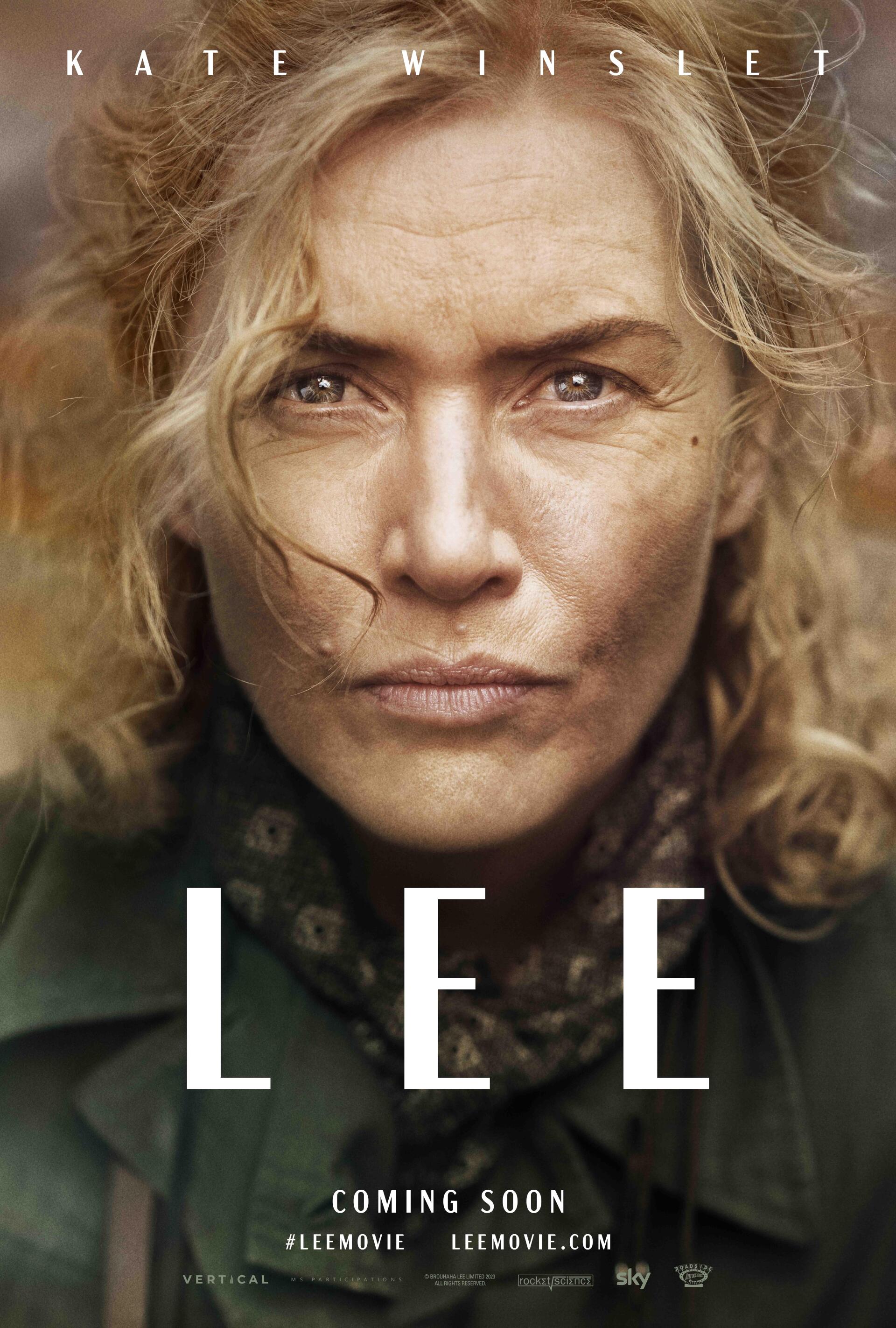 A dramatic movie wallpaper featuring Kate Winslet as a fierce character in Lee (2023), showcasing her intense expression and the film's title prominently displayed.