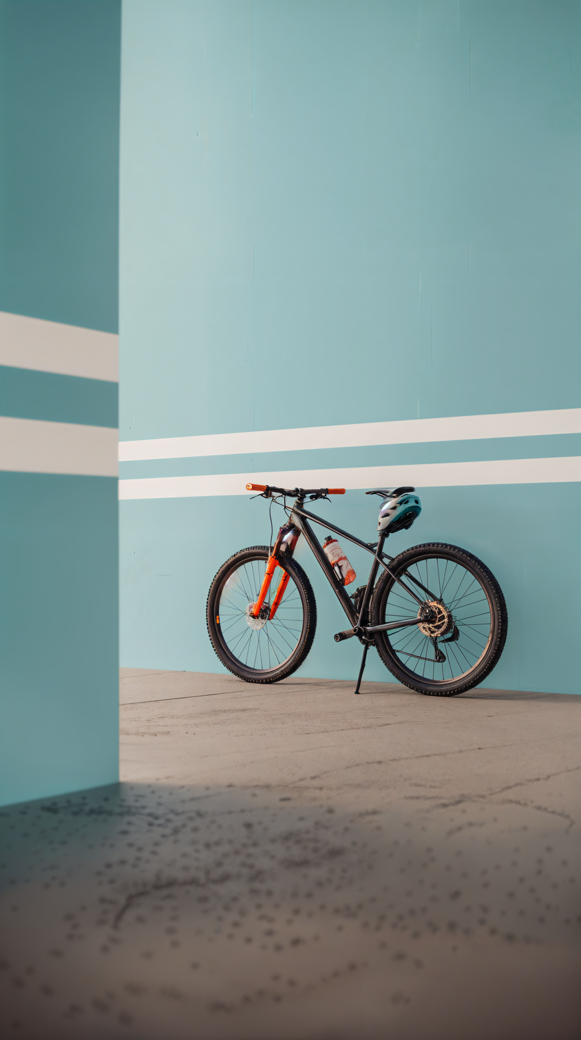 A sleek bike with orange accents leans against a vibrant blue wall, complemented by a helmet, creating a stylish phone wallpaper.