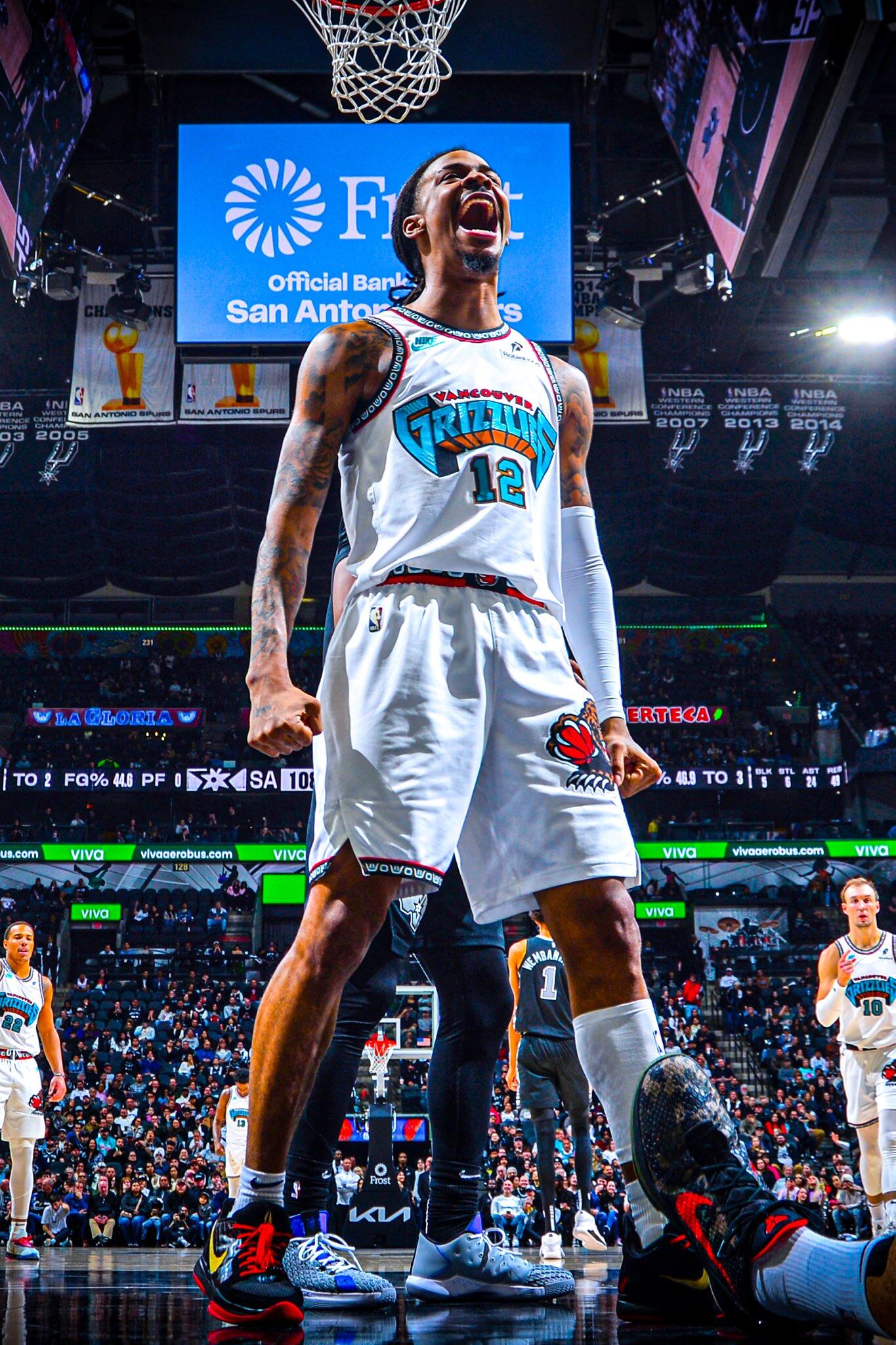 Ja Morant of the Memphis Grizzlies celebrates passionately on the court during an NBA game, surrounded by teammates and fans, showcasing his dynamic energy and basketball prowess.