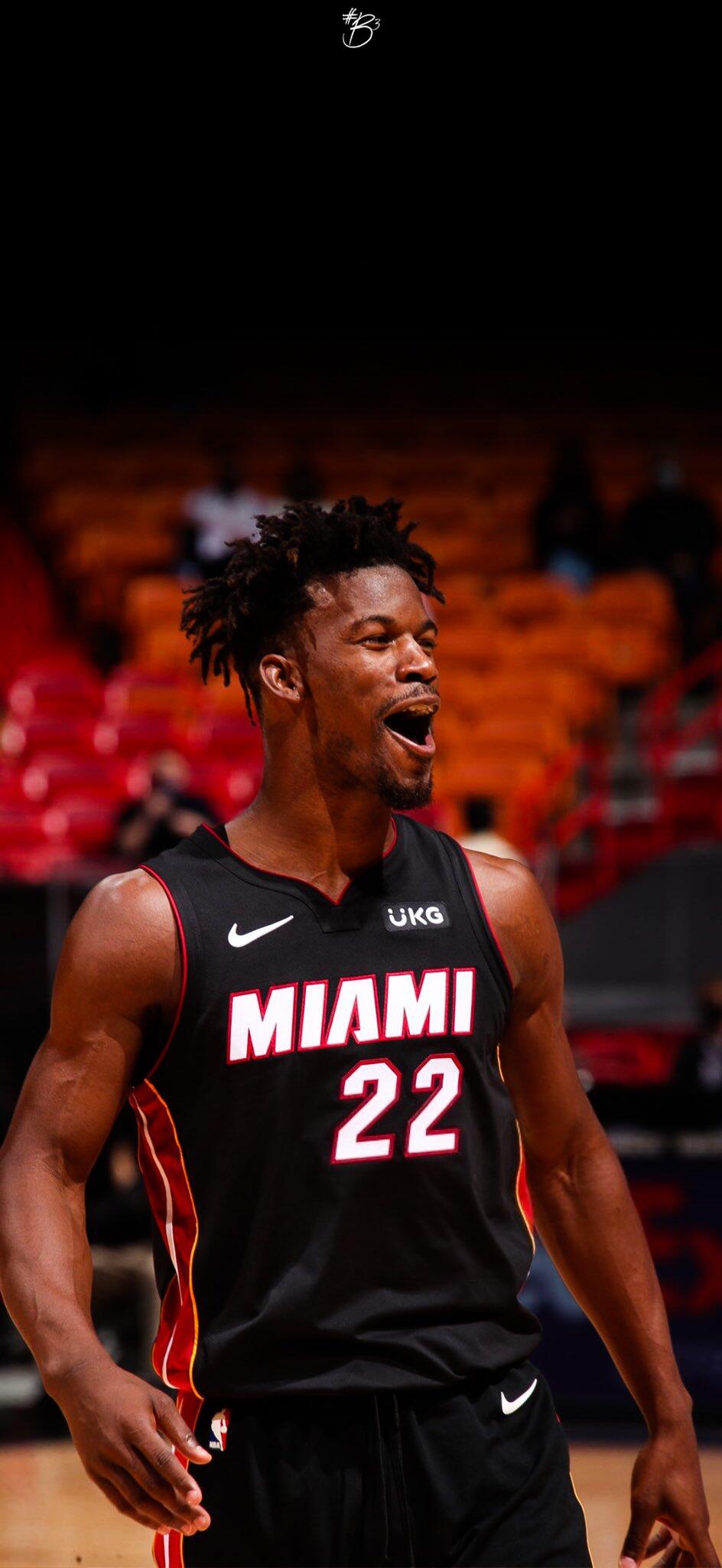Jimmy Butler celebrates on the court in a Miami Heat uniform, showcasing his passion for basketball. This vibrant image captures the excitement of NBA sports.