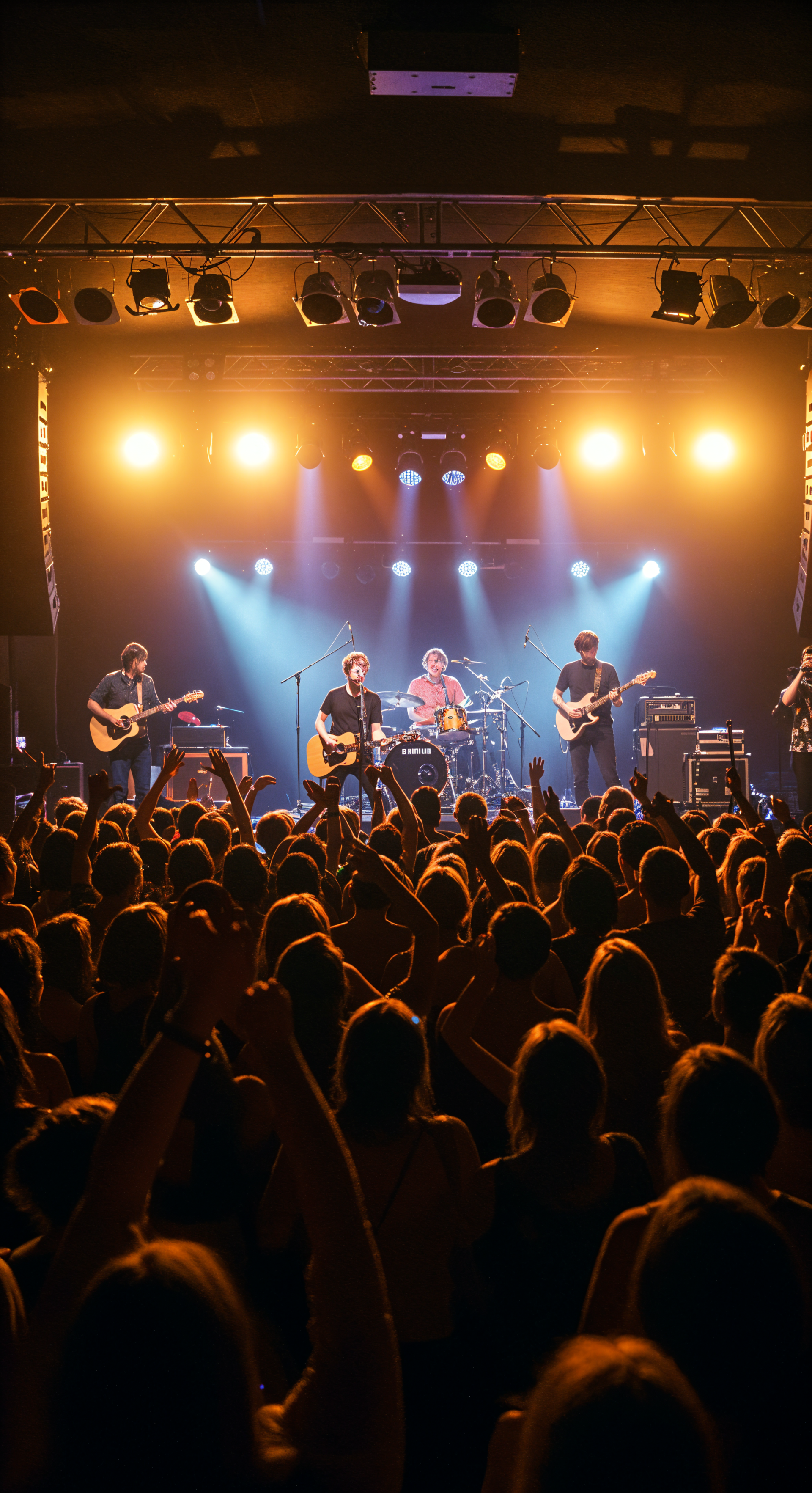 Phone wallpaper showing a vibrant concert scene with a band performing on stage under bright lights, capturing the energy of a packed audience on iPhones and Android devices.