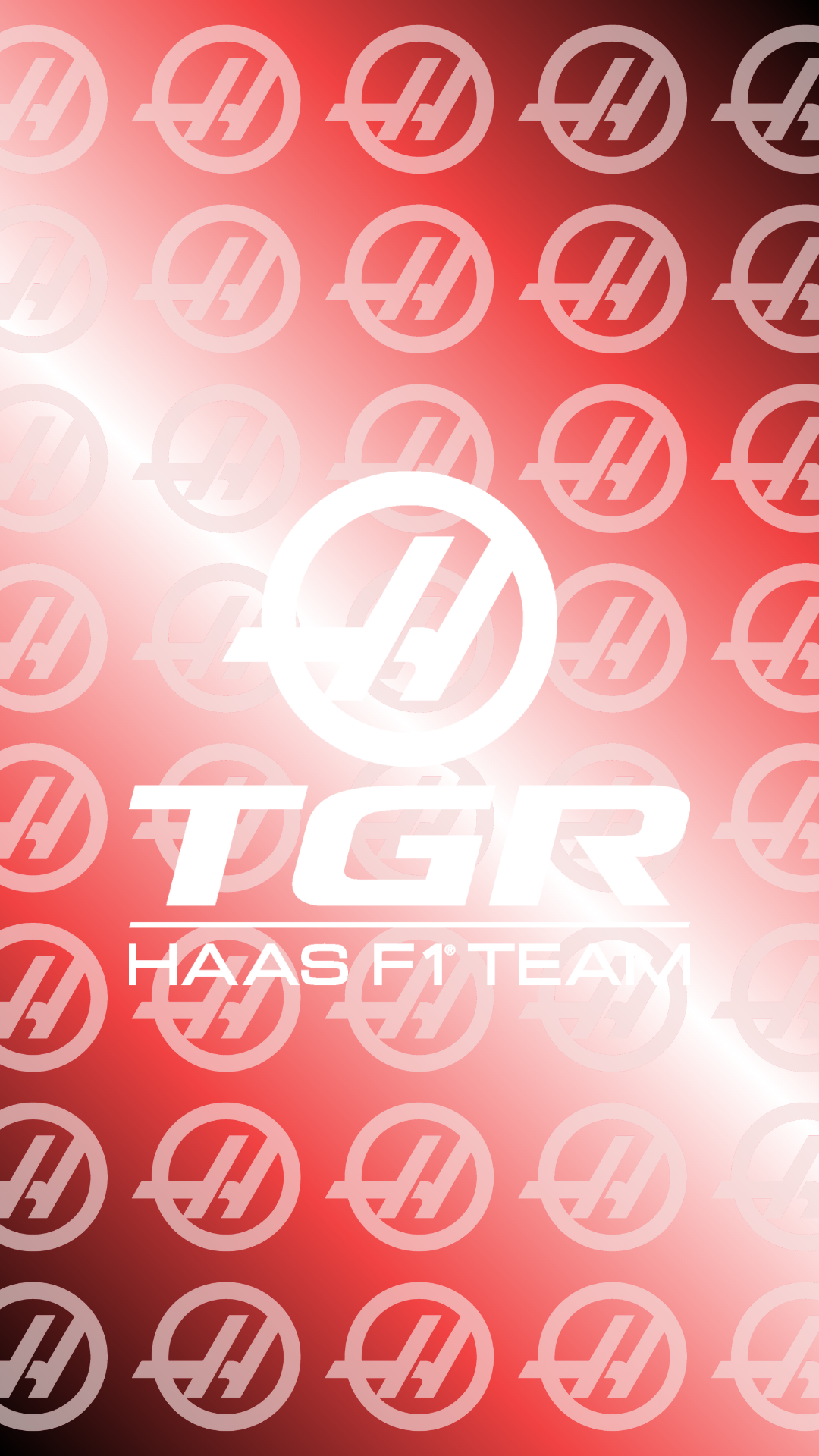 Phone wallpaper showing repeated Haas F1 Team logos on red background with central TGR and HAAS F1 TEAM text — F1 team racing/car branding referencing races and team identity.
