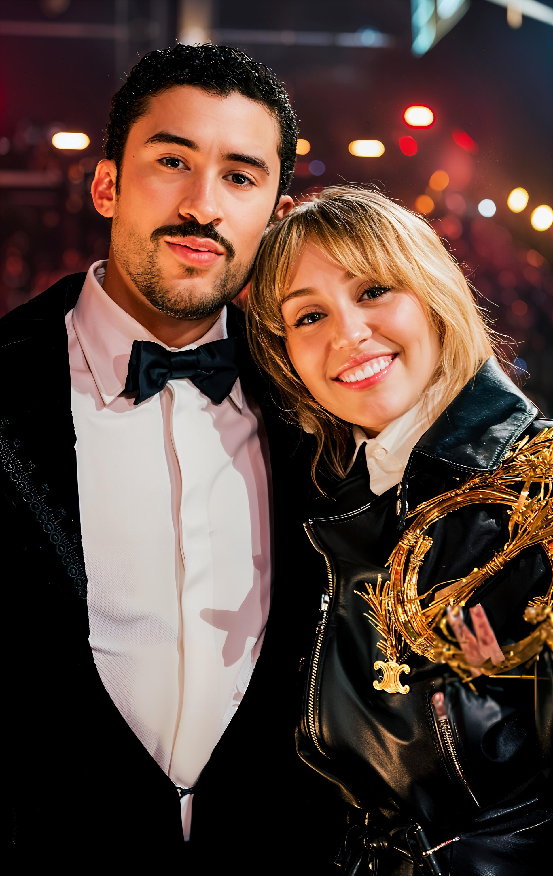 Phone wallpaper of two smiling musicians at the Grammy Awards — one in a tuxedo, the other in a leather jacket holding a Grammy trophy against glowing city lights.