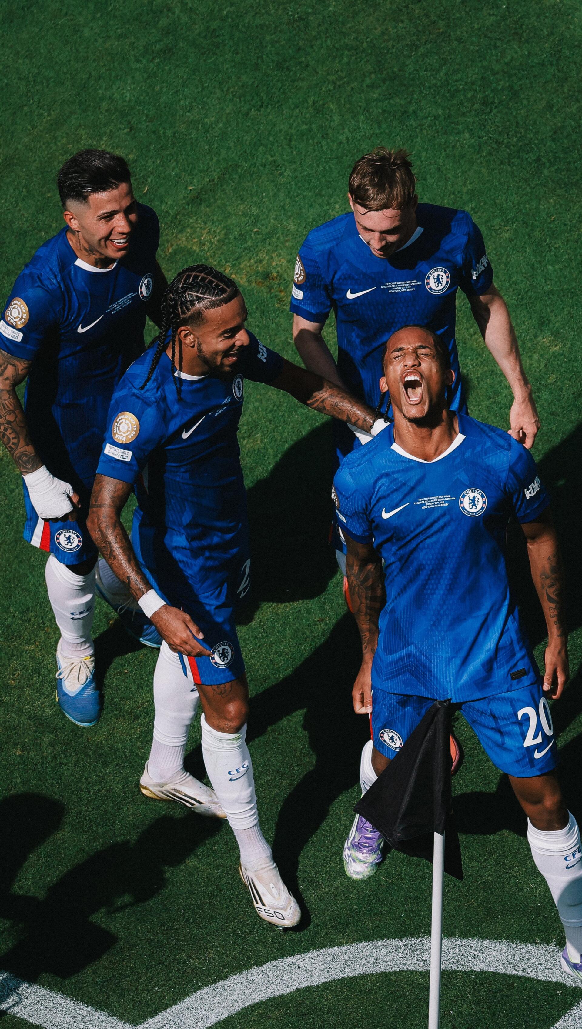 Chelsea F.C. phone wallpaper of four players in blue celebrating by the corner flag, teammates cheering and embracing on the pitch.