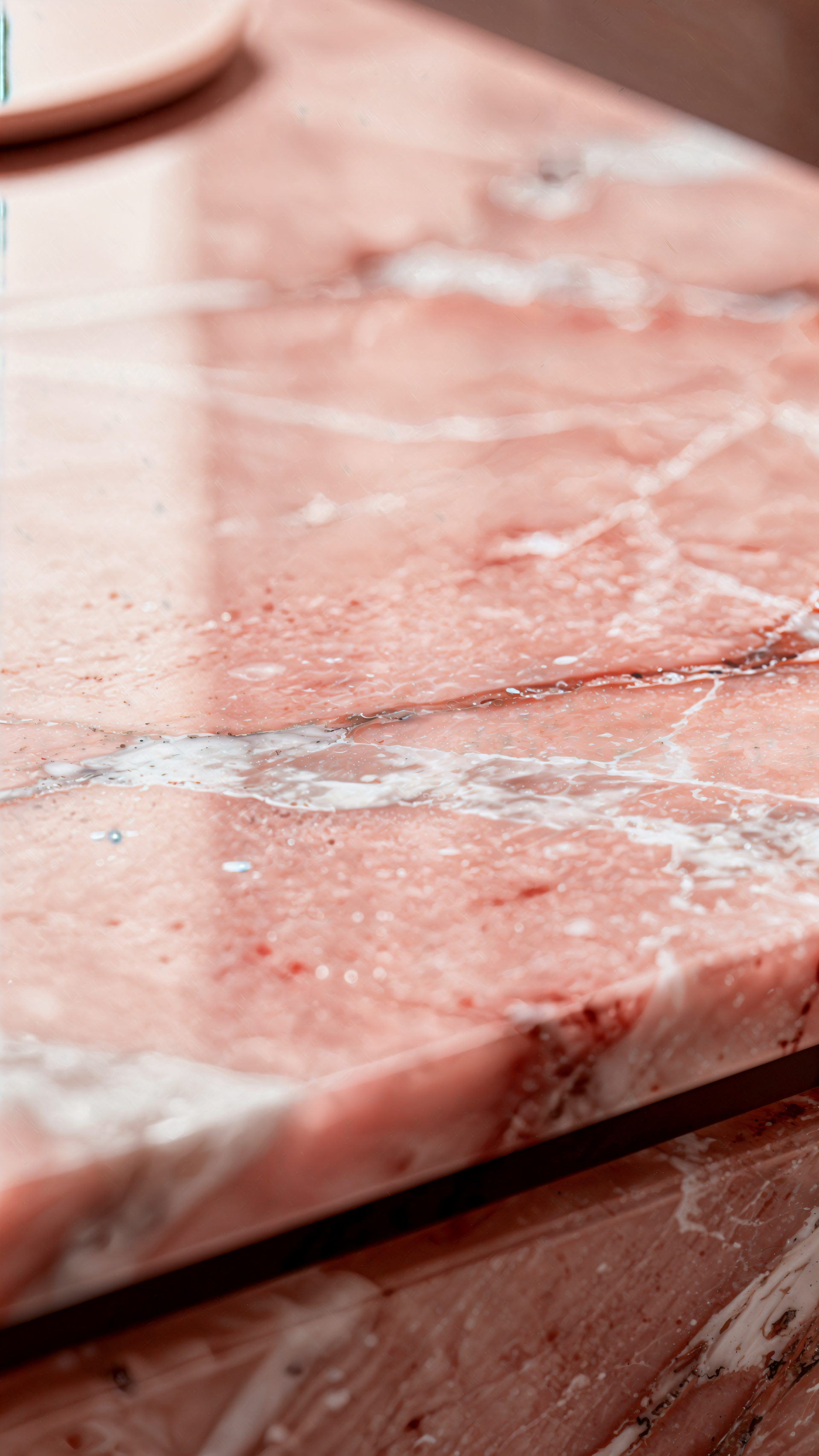 Close-up pink marble texture with white veining and glossy sheen, cropped as a vertical iPhone wallpaper.