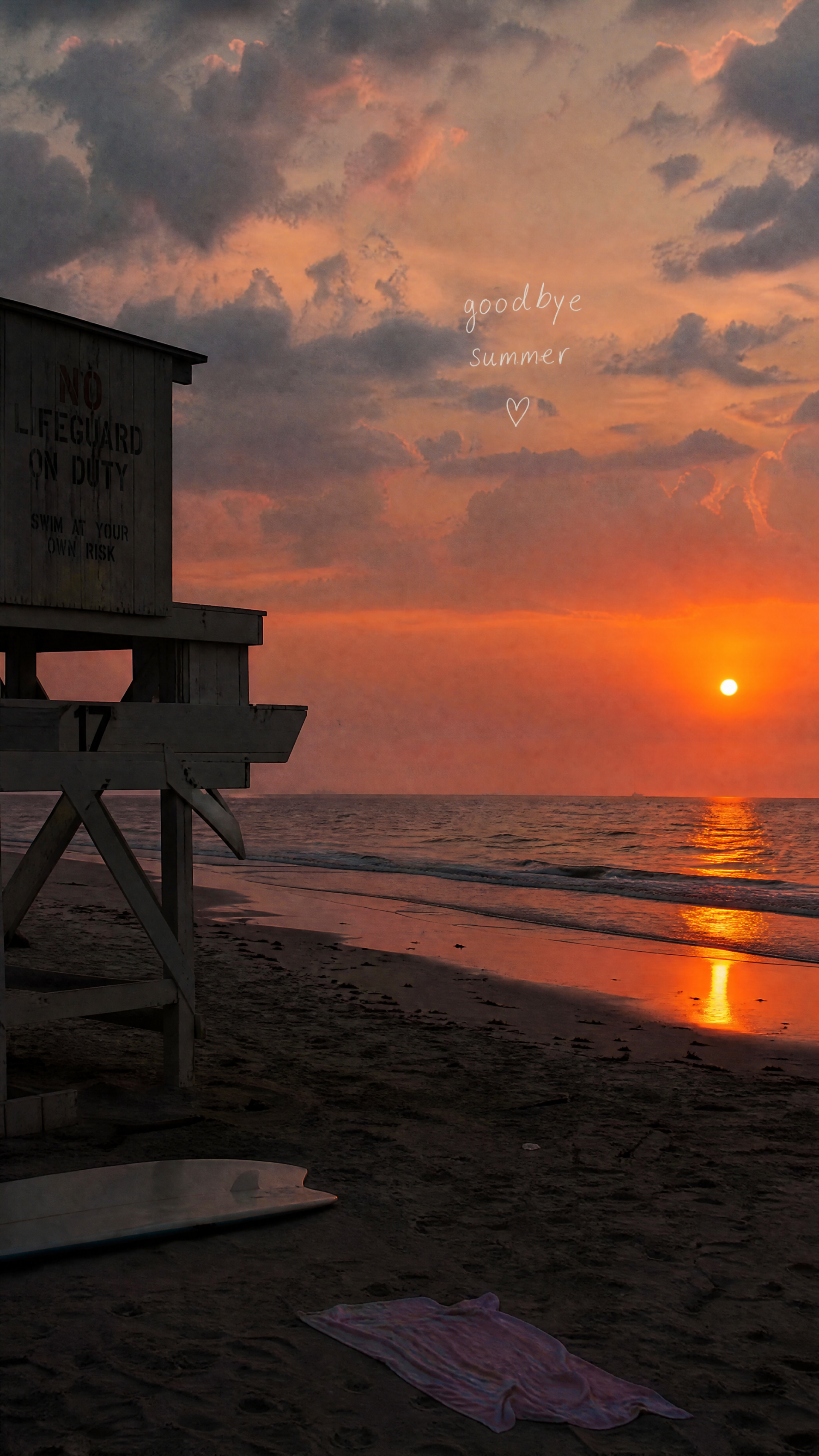Vertical iPhone wallpaper of a lifeguard tower silhouetted on a sandy beach at sunset over the ocean, orange-pink sky with handwritten goodbye summer text — an end-of-summer scene.