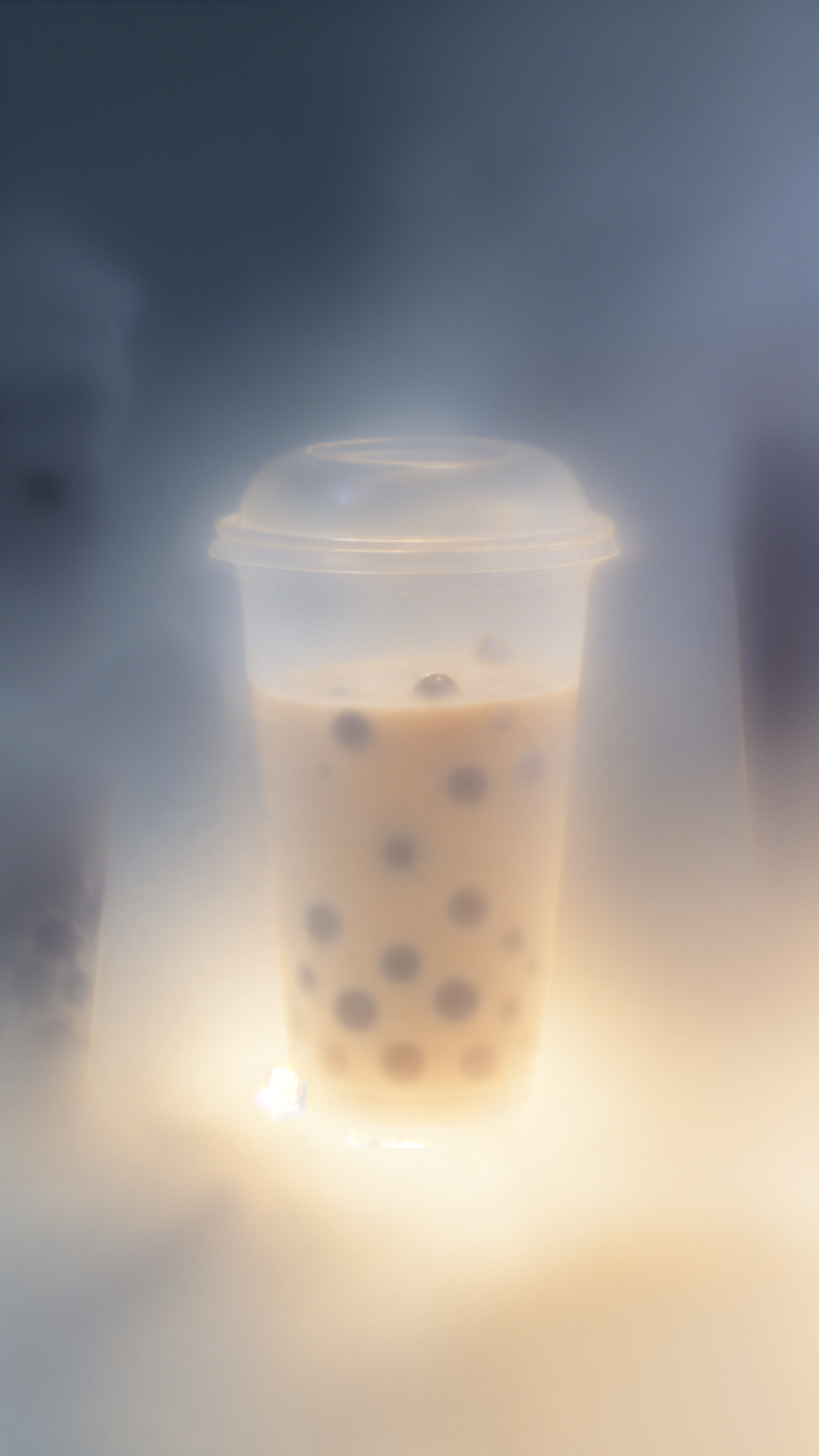 Dreamy bubble tea with tapioca pearls glowing in soft light, a cozy boba tea phone wallpaper.