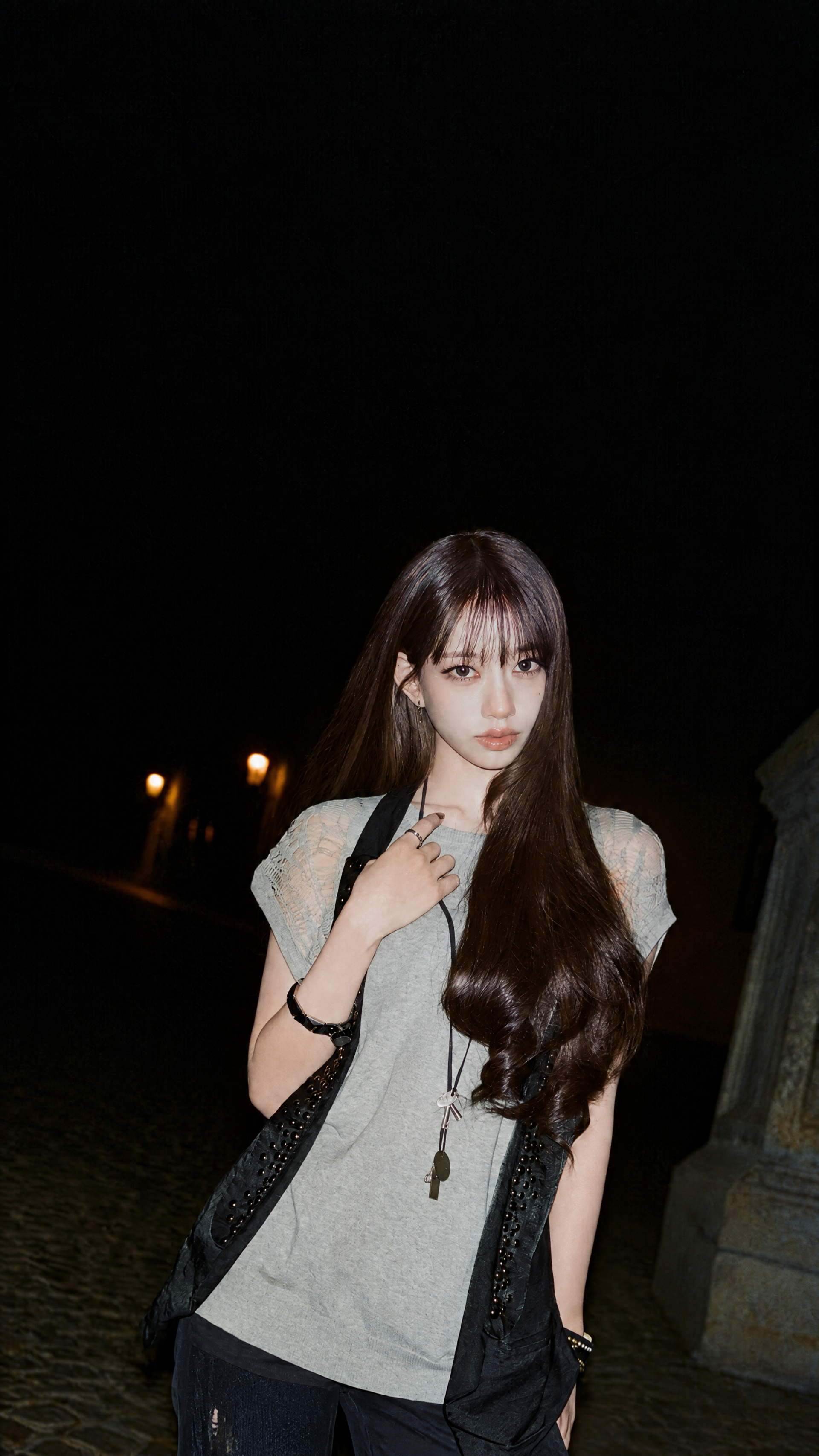 MEOVV woman in a chic street-fashion portrait at night, from the GO HARD era, formatted as an iPhone wallpaper.