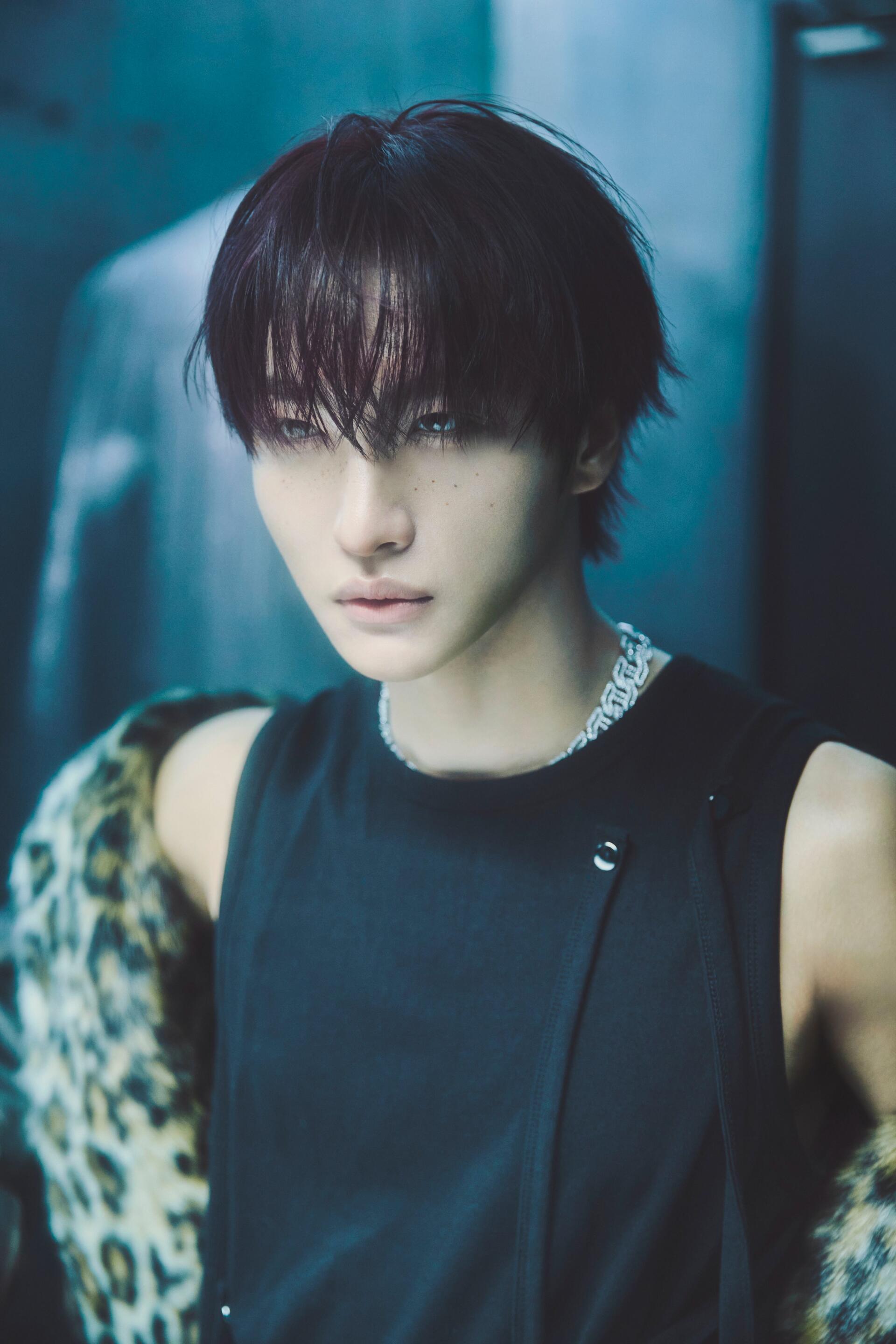 ATEEZ Seonghwa portrait phone wallpaper from Golden Hour, featuring the singer in a black sleeveless top against a moody blue backdrop.