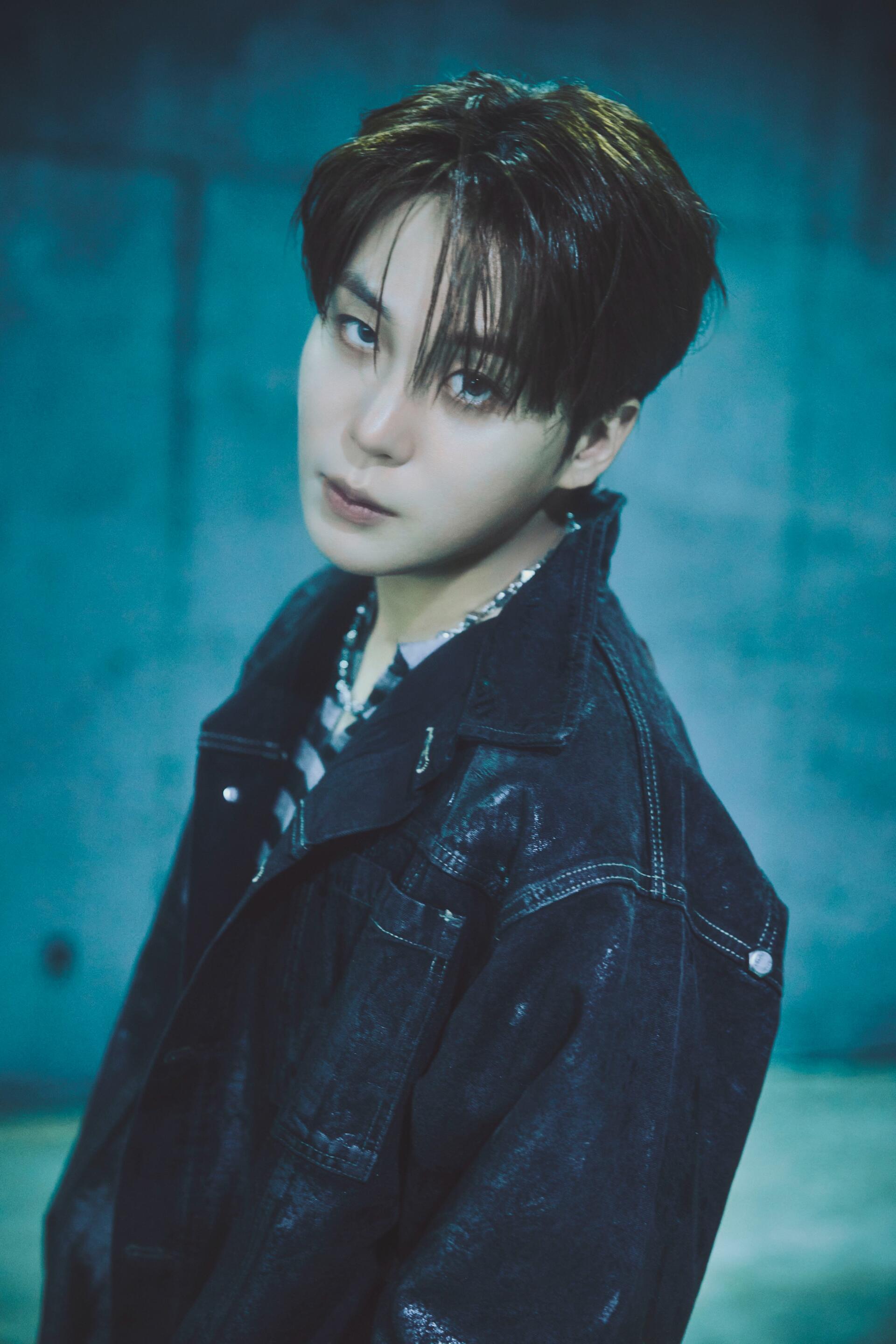 ATEEZ Jongho portrait in a dark jacket against a teal backdrop, Golden Hour iPhone wallpaper.