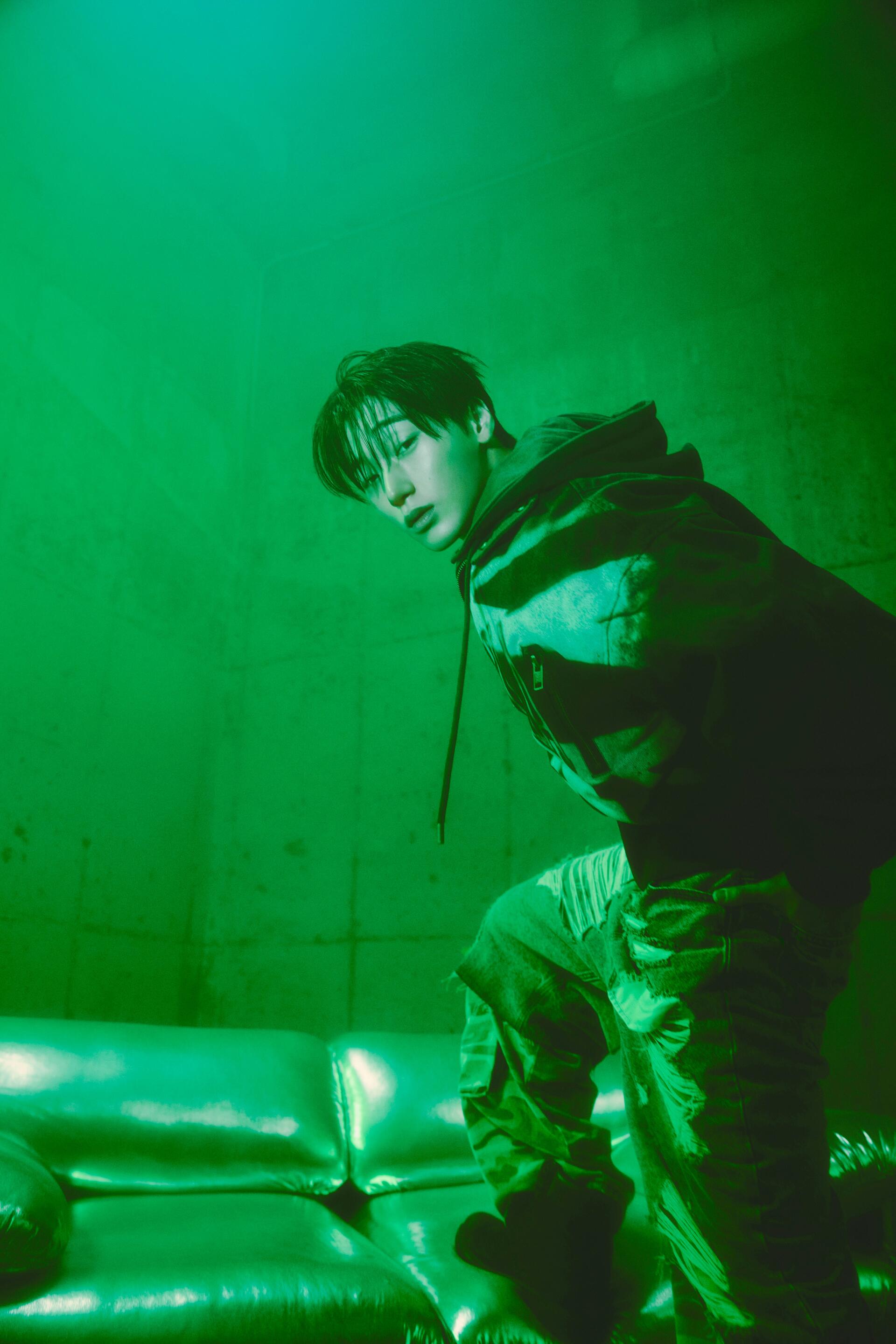 Green-toned San of ATEEZ portrait from Golden Hour, styled as a dramatic iPhone wallpaper.