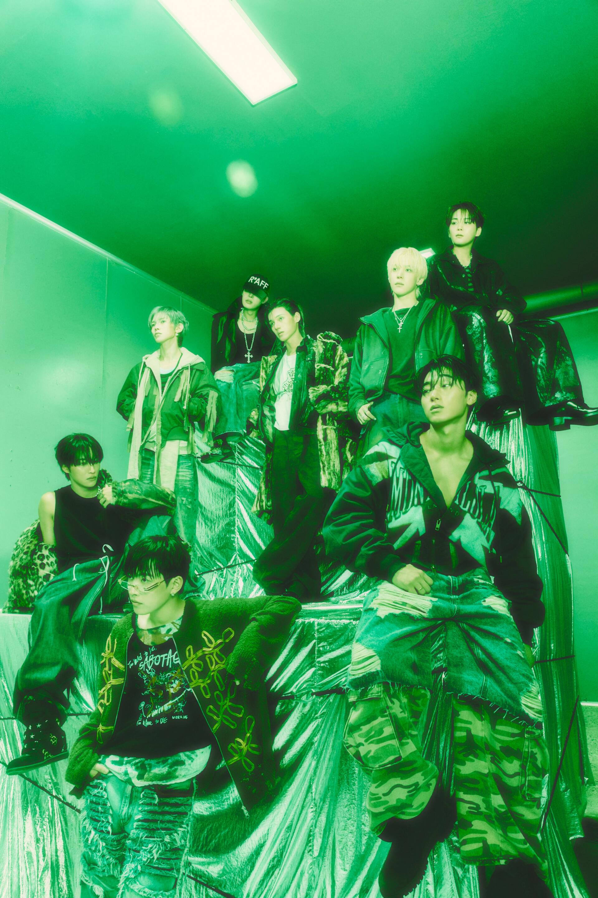 ATEEZ Golden Hour group portrait in bold streetwear under green lighting, styled as an iPhone wallpaper.