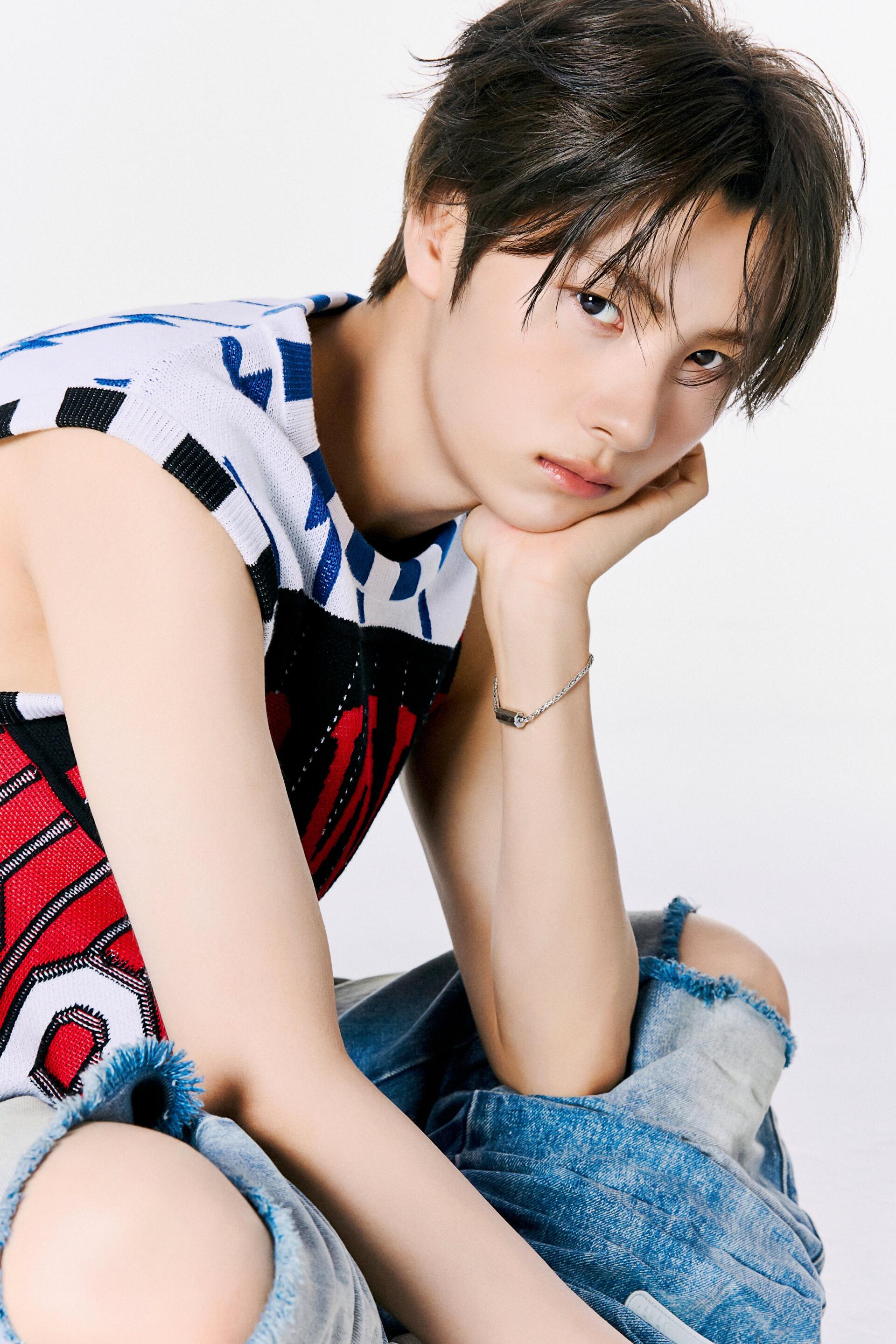 TWS Youngjae fashion portrait in a patterned sleeveless top and jeans, phone wallpaper