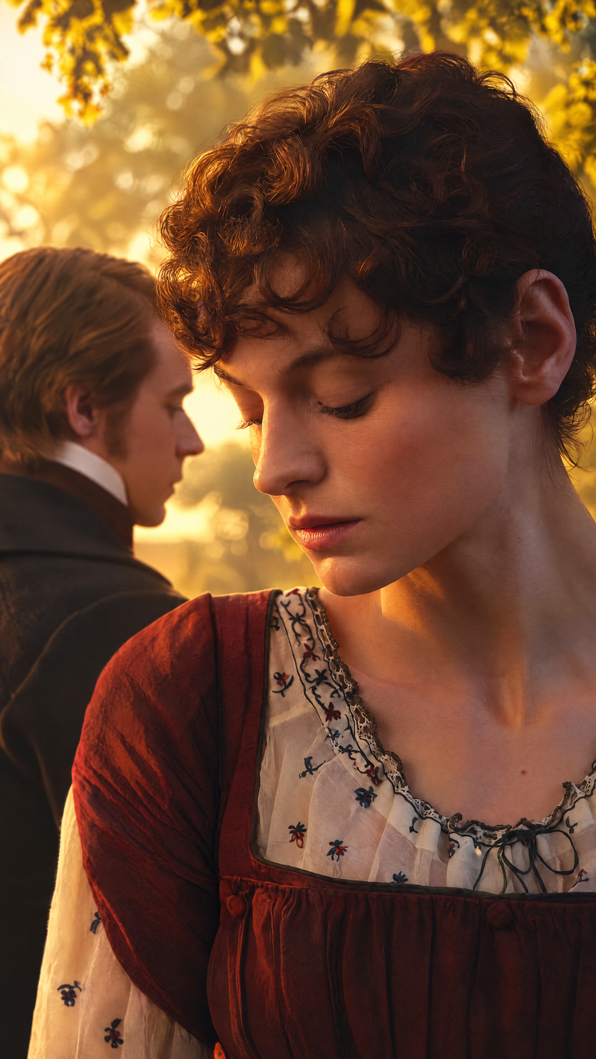 Emma Corrin and Jack Lowden in a golden-hour Pride and Prejudice (2026) portrait, framed as an iPhone wallpaper.