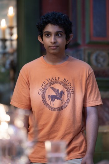 Wallpaper image of a character from the TV show Percy Jackson and the Olympians, wearing a Camp Half-Blood T-shirt.