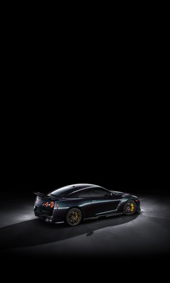 Nissan GT-R T-Spec Takumi Edition showcased in sleek black with striking yellow accents, set against a dark background, making an eye-catching phone wallpaper.
