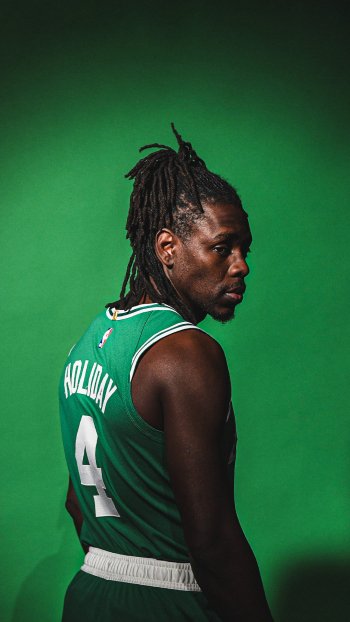 Jrue Holiday poses in a green Boston Celtics jersey, showcasing his number 4 on a vibrant green backdrop, creating an energetic phone wallpaper for NBA fans.