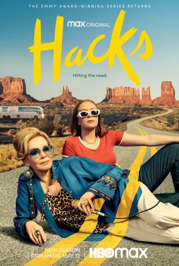 Phone wallpaper featuring a promotional poster for the TV show Hacks (2021), depicting two women posing in front of desert scenery, symbolizing the show's road trip theme.