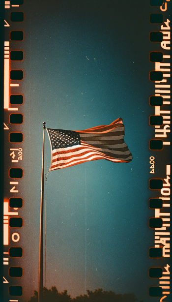 A vibrant American flag waves against a clear blue sky, framed by a vintage film strip, making it an eye-catching phone wallpaper.