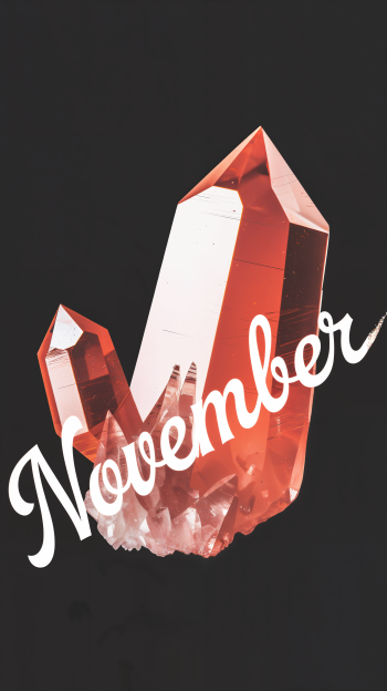 A striking phone wallpaper featuring a cluster of rose-colored crystals with the word November elegantly overlaying the design.