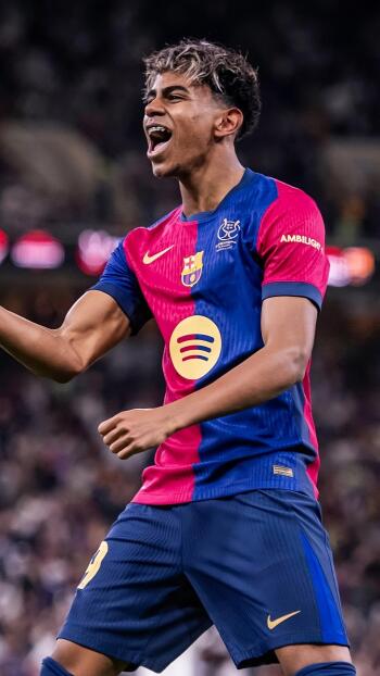 Lamine Yamal celebrates a goal wearing the iconic FC Barcelona jersey in this vibrant phone wallpaper, capturing the energy of soccer on the pitch.