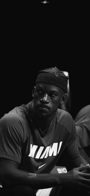 A striking black-and-white phone wallpaper featuring Miami Heat player Jimmy Butler, showcasing his focused expression during a basketball game, embodying the intensity of the NBA.