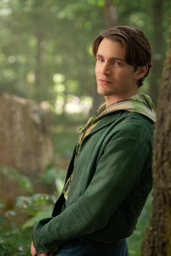 Phone wallpaper featuring Andrew Burnap from the movie Snow White (2025), set against a soft-focus forest background. Compatible with iPhones and Android phones.