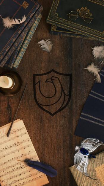A Ravenclaw-themed phone wallpaper featuring the house emblem, vintage books, a quill, music sheet, and decorative elements, perfect for Harry Potter fans on iPhones and Androids.