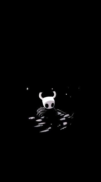 Black & white Hollow Knight wallpaper for iPhone and Android: tiny white horned-masked Knight crouches among stones at center of a tall black frame.