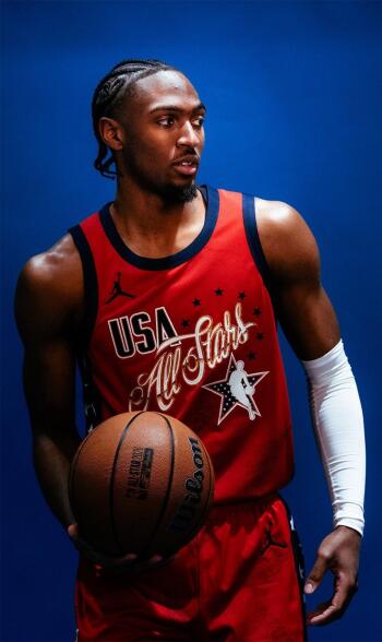 Phone wallpaper of an NBA All-Star Game player in a red USA All-Stars jersey holding a basketball against a deep blue background.