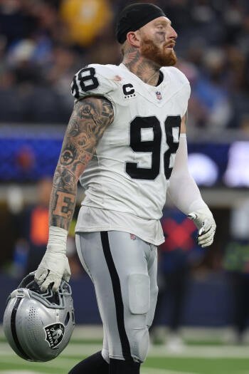 Phone wallpaper: NFL defensive lineman in silver #98, red-bearded and heavily tattooed, holding his helmet — sports image tagged Baltimore Ravens.