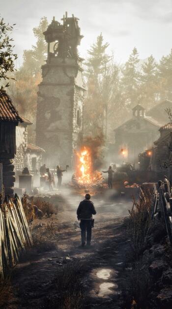 Resident Evil 4 video game iPhone wallpaper: lone figure walks down a foggy village lane toward a blazing pyre beneath a crumbling bell tower, silhouetted villagers and looming trees.