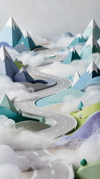 iPhone wallpaper of a foggy mountain pass: a winding road through stylized snow-capped peaks veiled in mist, with soft pastel blues and greens.