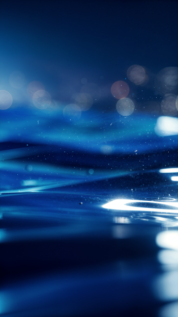 Vertical blue-aesthetic iPhone wallpaper: soft-focus shimmering water ripples and bokeh lights in deep blue tones with subtle, glowing highlights.