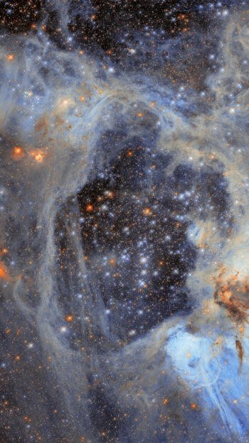 iPhone wallpaper showing a Hubble Space Telescope nebula: swirling blue-gray gas and dust framing a dense field of bright stars in deep space.