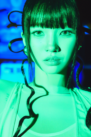High-contrast green-lit portrait of a woman with straight bangs and sculpted curls framing her face; cinematic iPhone wallpaper inspired by What a Wonderful Life.