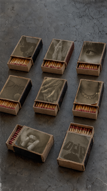 ATEEZ Golden Hour “Drip” iPhone wallpaper with vintage matchboxes and matchsticks on a cracked stone surface.