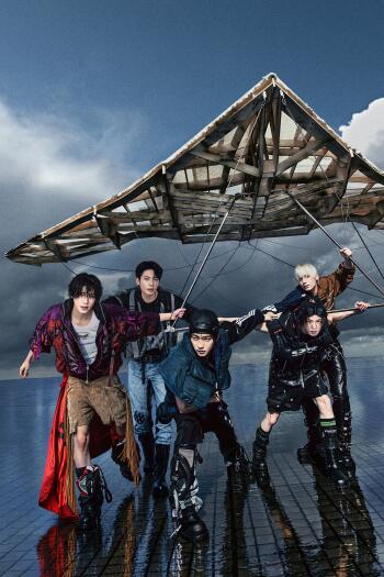 TXT models pose beneath a wrecked aircraft wing in stormy fashion imagery for the Perfect Storm “Ride the Storm” iPhone wallpaper.