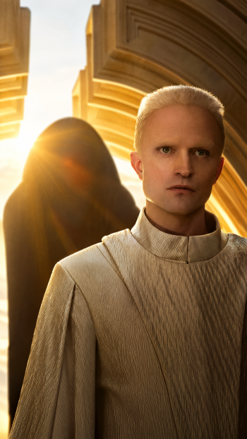 Robert Pattinson in a cream robe beneath golden futuristic architecture in Dune: Part Three sci-fi iPhone wallpaper.